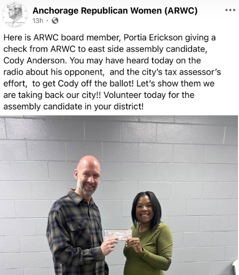 Cody Anderson receives a handout from the far-right Anchorage Republican Women's Club, led by Judy Eledge.
